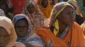 Pan left to right across group of Sudanese women sitting at refugee camp&sbquo;  Darfur; Sep 04