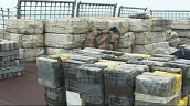 Pan right across 1.7 tons of parcelled cocaine lined along deck of coast guard ship&sbquo;  Key West&sbquo; Florida