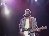 All Star Band including Jools Holland on piano&sbquo;  Phil Collins on drums&sbquo; Midge Ure on guitar&sbquo; Eric Clapton sings \%27Behind The Mask\%27&sbquo; Rock Gala&sbquo; Wembley Arena&sbquo; London; 6 June 1987