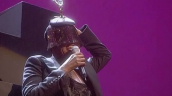 Grace Jones performs \%27Pull up to the Bumper\%27 wearing Spirit of Ecstasy Rolls Royce mascot hat as models parade by wearing Stella McCartney designs&sbquo;  Fashion Rocks&sbquo; Royal Albert Hall&sbquo; London; 15