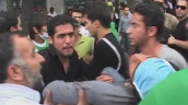 Injured Iranian man is lifted from ground during demonstration against presidential elections&sbquo;  Tehran; 13 June 09