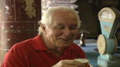 Train robber Ronnie Biggs holds glass of beer while laughing and joking at bar&sbquo;  Brazil; November 1997