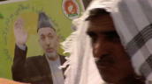 Men walk past campaign poster of President Hamid Karzai ahead of presidential elections&sbquo;  Afghanistan; 16 August 2009
