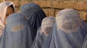 Afghan women dressed in burqas wait in line to place their votes in presidential elections&sbquo;  Afghanistan; 20 August 2009