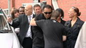 Zoom in to boxing legend Muhammad Ali as he waves to crowd hugs former British Champion Ricky Hatton during visit to sports club in Manchester&sbquo;  UK; 26 August 2009