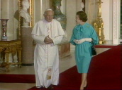 Queen Elizabeth II leads Pope John Paul II through corridor in Buckingham Palace; 28 May 82