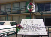 Wreath on railings zoom out to motel and plaque commemorating Martin Luther King Jr&sbquo;  Memphis