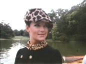 Two female models walk side by side past lake wearing sixties style mini skirts&sbquo;  patterned tights and hats&sbquo; Central park; 1960\%27s