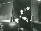 The Beatles walk off train as they arrive in Washington DC&sbquo;  Paul McCartney is interviewed and Ringo Starr is smoking; 11 Feb 64