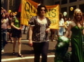 Drag Queens march along street with large yellow banner&sbquo;  USA; 1970s