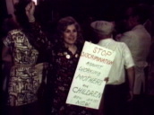 Woman holding sign "stop discrimination against working mothers now"&sbquo;  USA; 1970s