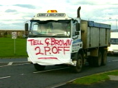 Lorry leads go slow demonstration with sheet on front - "tell G Brown 2 P off"&sbquo;  Berwick; Nov 00