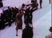 Prime Minister Winston Churchill arrives at St Paul\%27s Cathedral with wife and daughter for service commemorating end of World War II&sbquo;  and lifts top hat as greeting to audience&sbquo; VE Day&sbquo; London; May