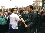 Crowd of people taking turns to strike Berlin Wall with sledgehammer; Nov 89