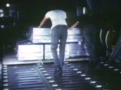 Two US soldiers push pallet of metal coffins deep into hold of aircraft&sbquo;  Saigon; 1960\%27s