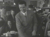 Howard Hughes in cafe having conversation stands up&sbquo;  then walks out smiling at camera&sbquo; Chicago&sbquo; Illinois; 1930\%27s