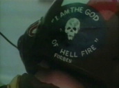 US army helicopter co-pilot adjusts his helmet decorated with the slogan&sbquo;  "I am the god of hellfire"&sbquo; Vietnam; 1960\%27s