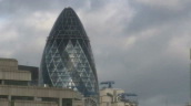 Sir Norman Foster\%27s 30 St Mary Axe building (aka Gherkin) rising above drab concrete skyline&sbquo;  London