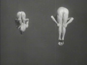 Two men jump from diving board and perform somersaults as they dive into water during diving display at World\%27s Fair&sbquo;  New York; 1939
