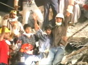 Rescuers on mountain of rubble retrieve male survivor after earthquake&sbquo;  Kashmir; 11 Oct 05