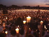Pan right over huge crowd as they raise their candles in air at vigil for AIDS&sbquo;  Washington DC; 10 Oct 92