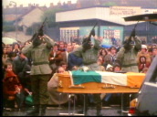 Piper leads funeral procession of hunger striker Bobby Sands&sbquo;  masked IRA members fire gun salute over coffin draped in Irish tricolour&sbquo; Northern Ireland; 7 May 81