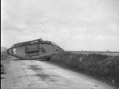 Large tank drives slowly over banked roadside and across road during World War I&sbquo;  France; 1910\%27s