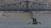 Two men row along Hai He River&sbquo;  Tianjin&sbquo; China; 2005