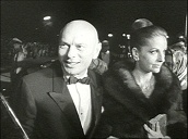 Chauffeur opens car door for Hollywood actor Yul Brynner who waves to fans on arrival at film premiere&sbquo;  Vienna; 1966