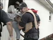 Little girl cries as she is passed to rescuers through window of flooded house following Hurricane Katrina&sbquo;  New Orleans; Sep 05