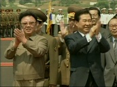 Following renewed relations between North and South Korea President Kim Jong Il and President Kim Dae Jung walk side by side applauding crowds at airport&sbquo;  Pyongyang; 15 Aug 00